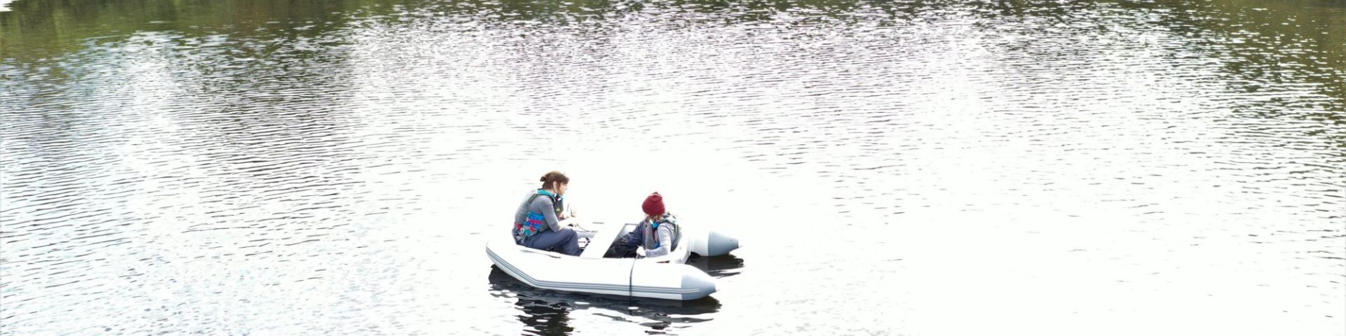 Scientists sampling protists from a boat on Priest Pot