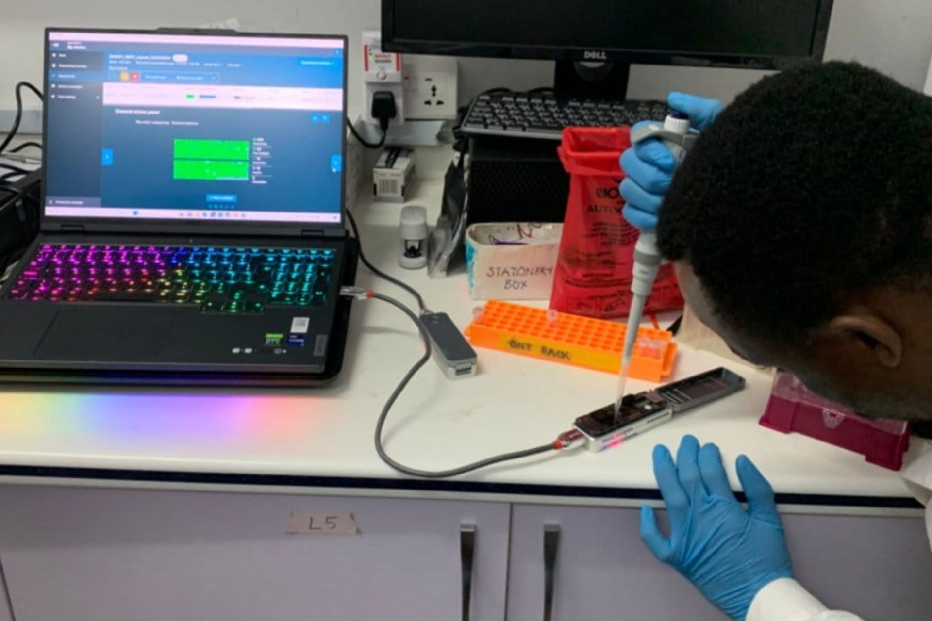 Scientist loading a DNA sequencer using a pipette