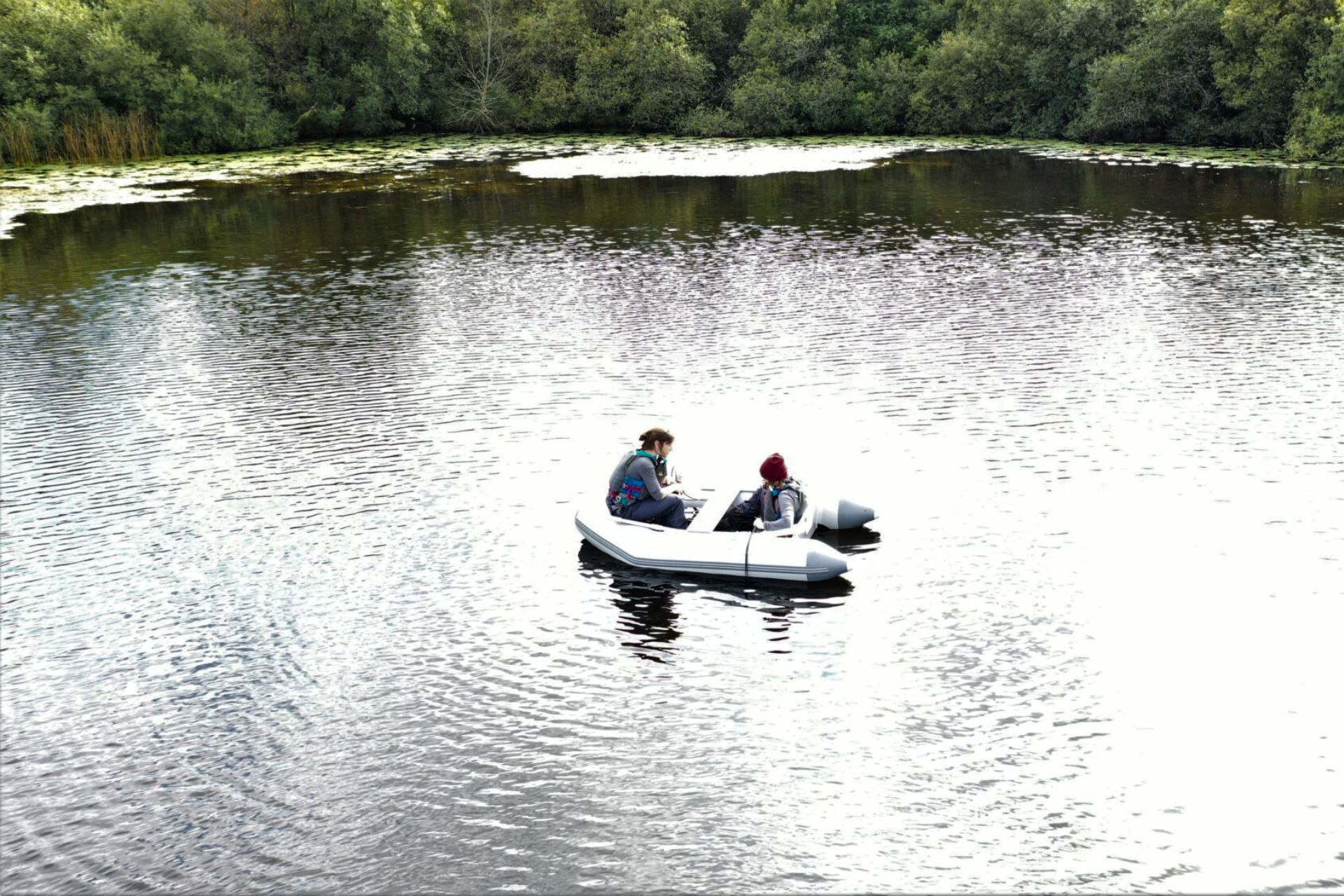 Scientists sampling protists from a boat on Priest Pot